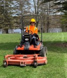 Student on riding lawnmower